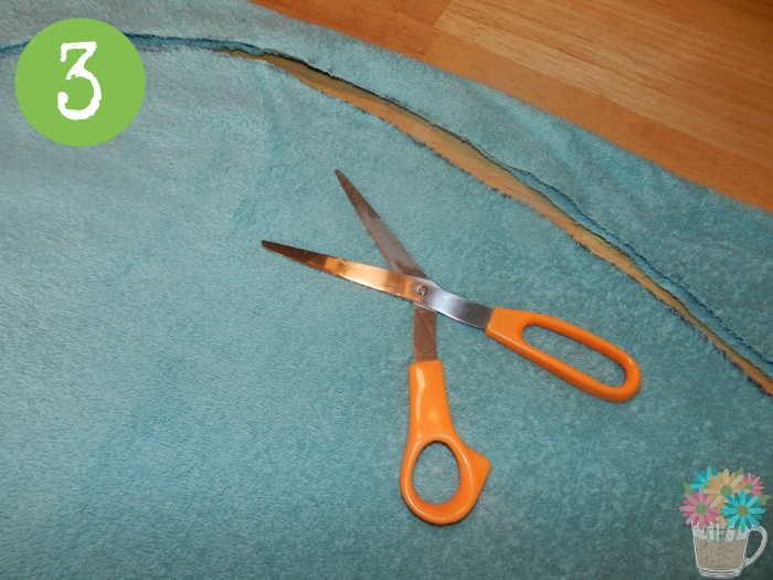 Step 3: Cut out the shape, making sure to cut through both layers of the towel. This is best done on a hard, flat surface.